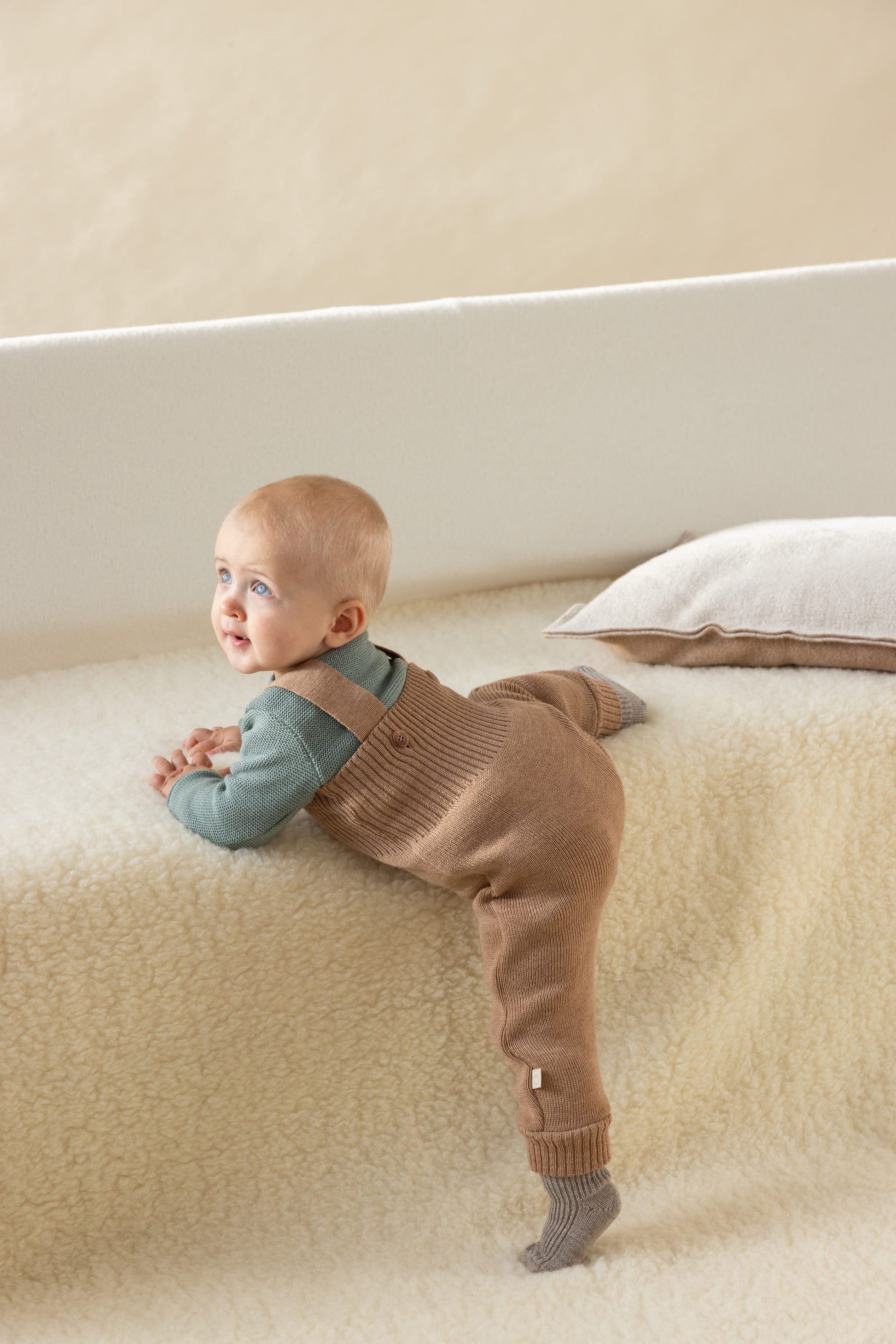 Zachte wollen salopette baby van Disana tijdens spelen