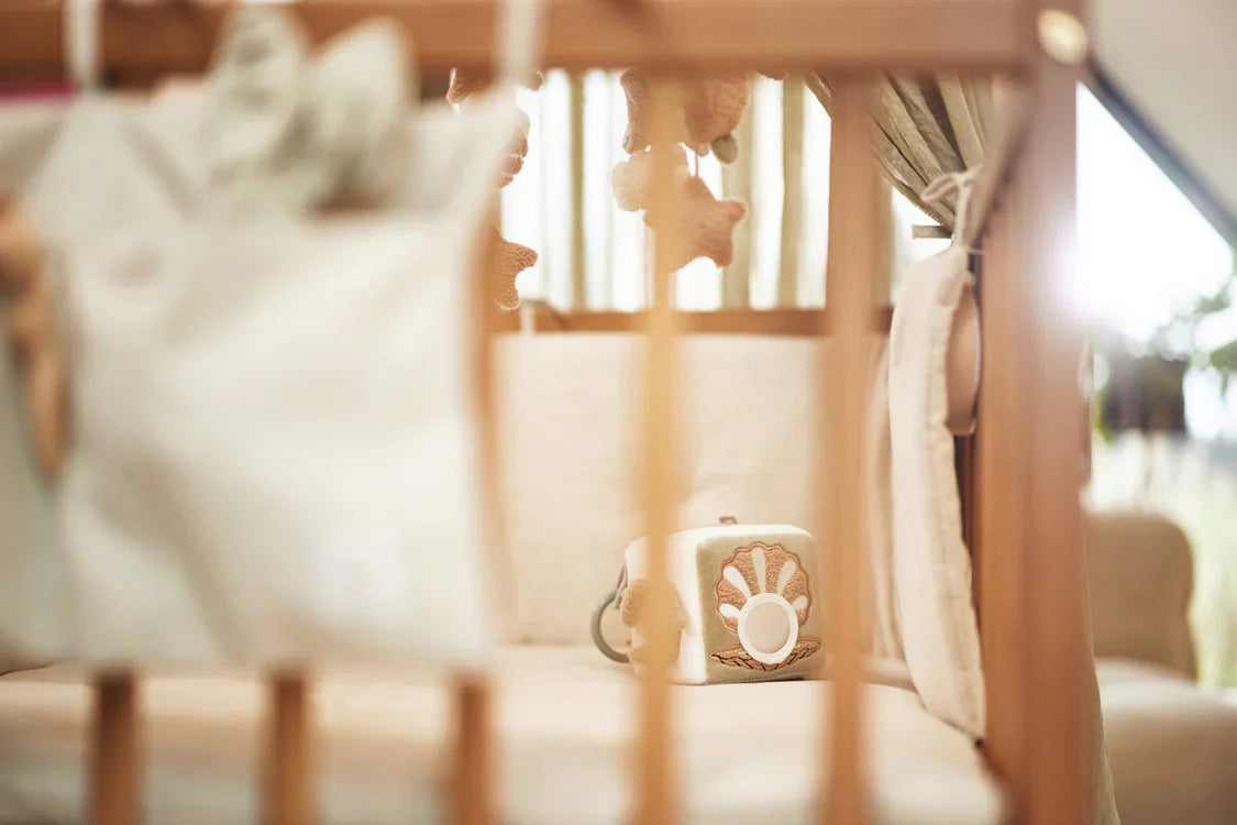 Sfeerbeeld van activiteitenkubus in box met kleurrijke tags en borduursels