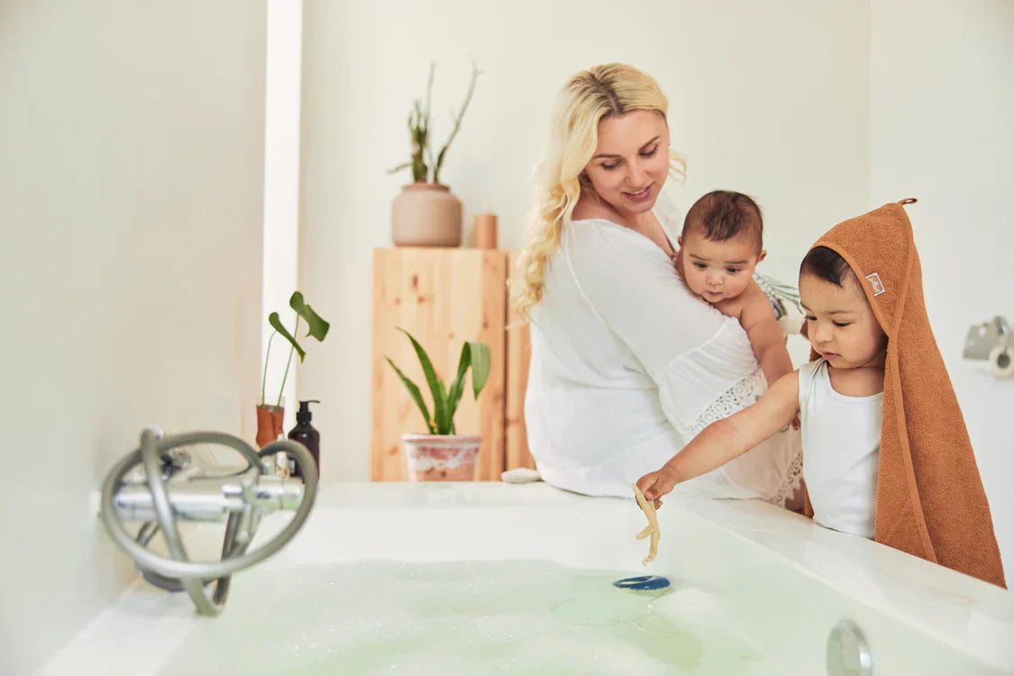 Sfeerbeeld van kindje in badcape na badmoment