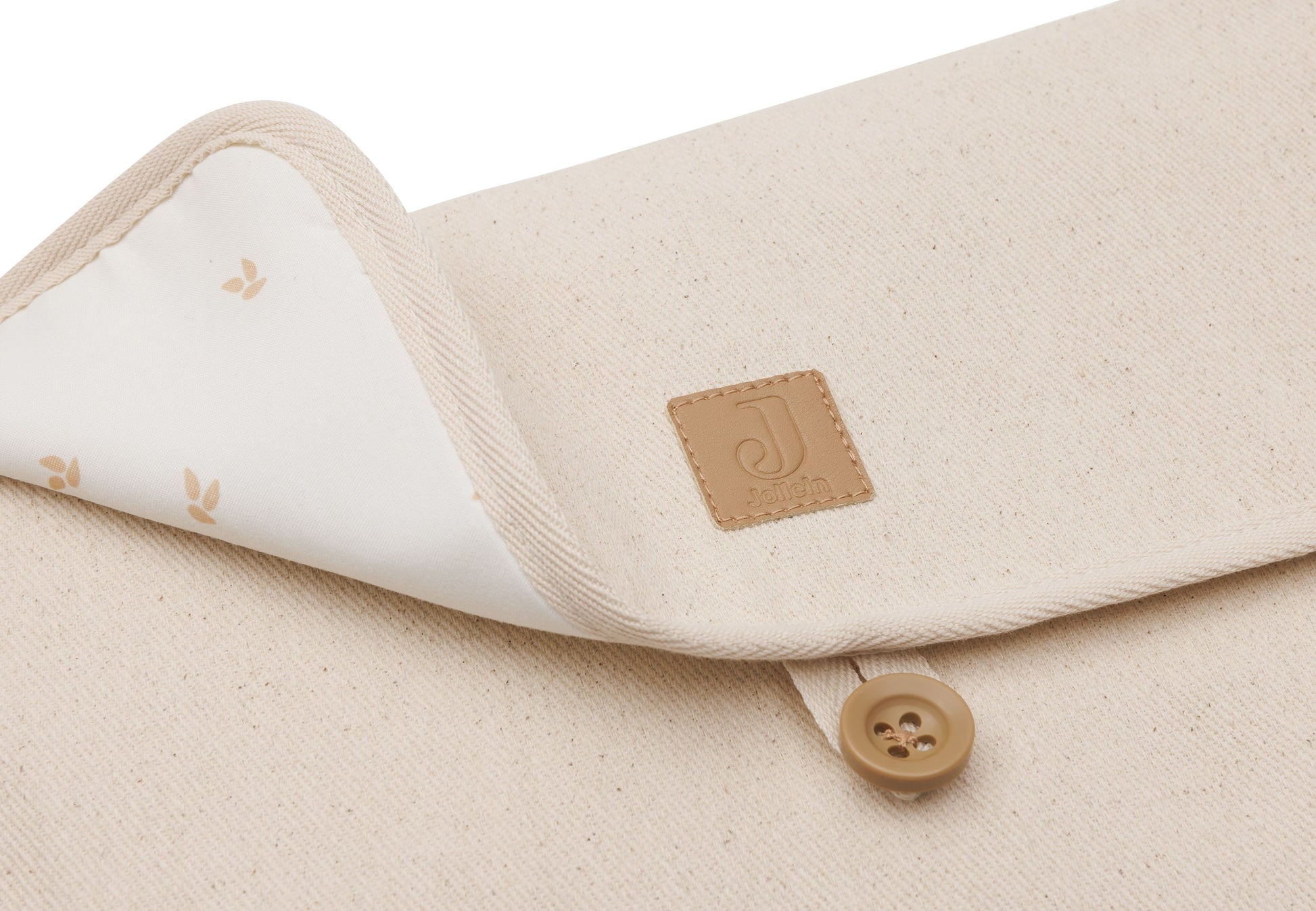 Zijaanzicht van compacte verschoningsmat met opbergvakken en twill stof