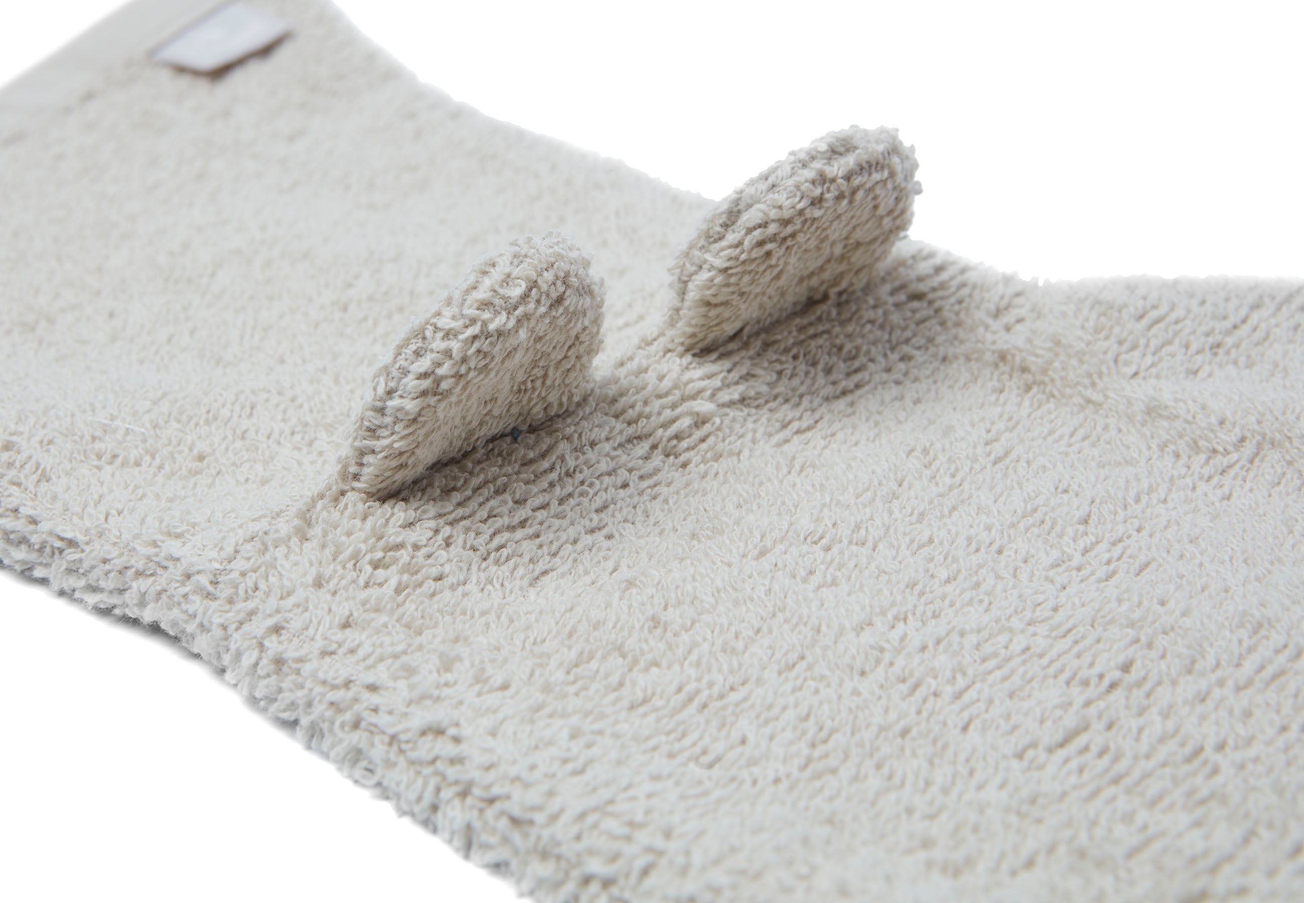 Detail van badstof structuur en stiksel in kleur nougat