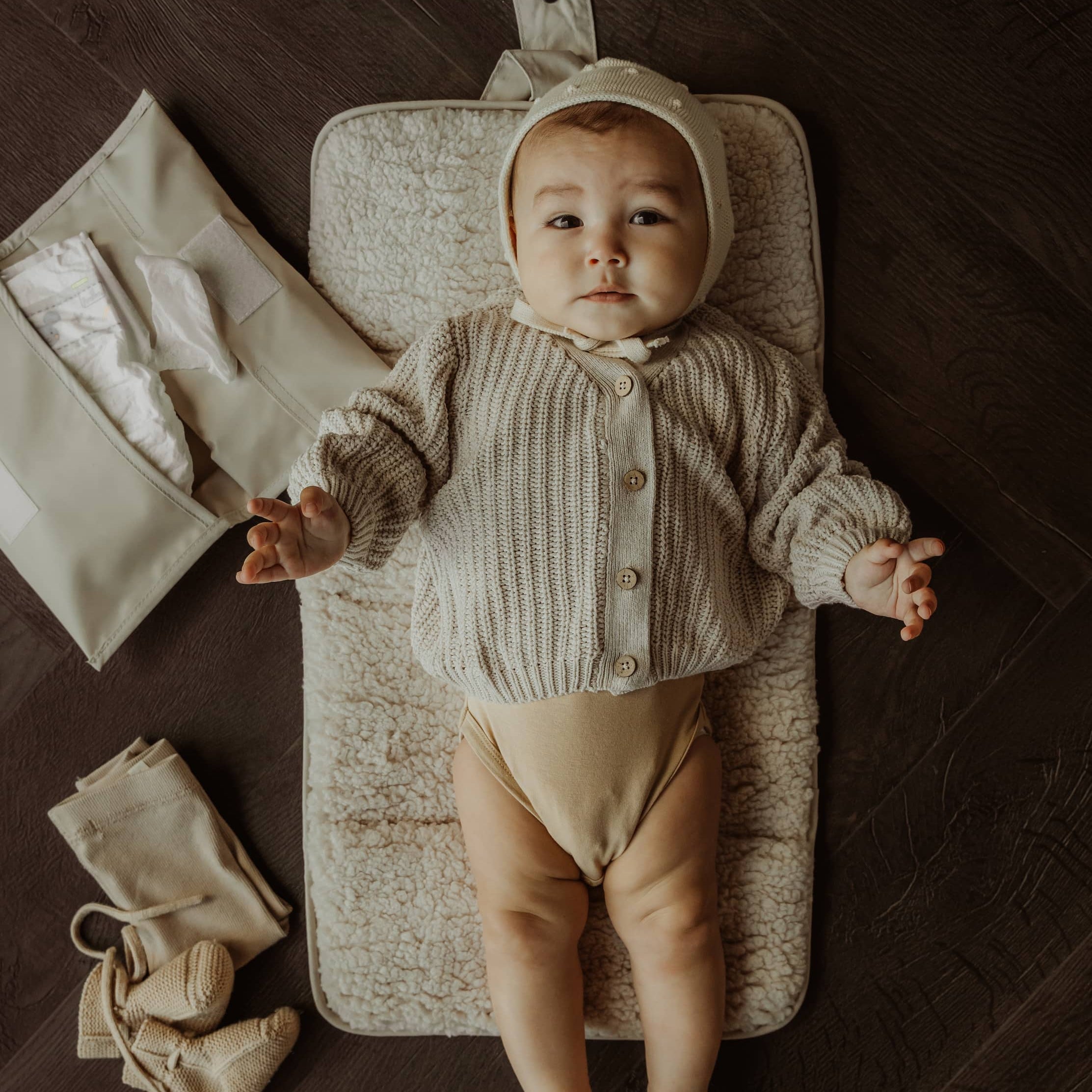Baby liggend op verschoonmatje en handige luieretui van KipKep