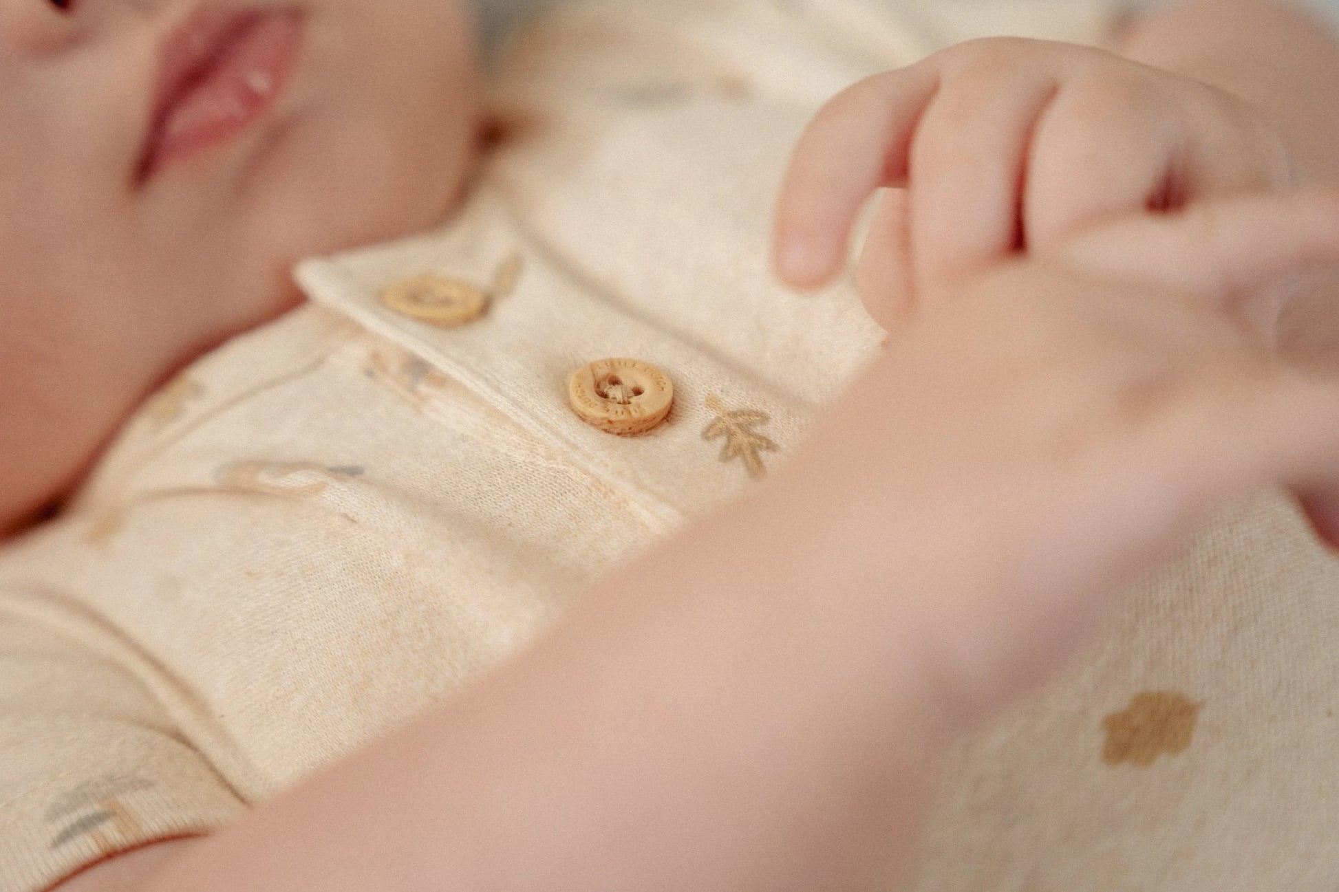 Baby romper zandkleur met Forest Friends print en houtlook knoopjes